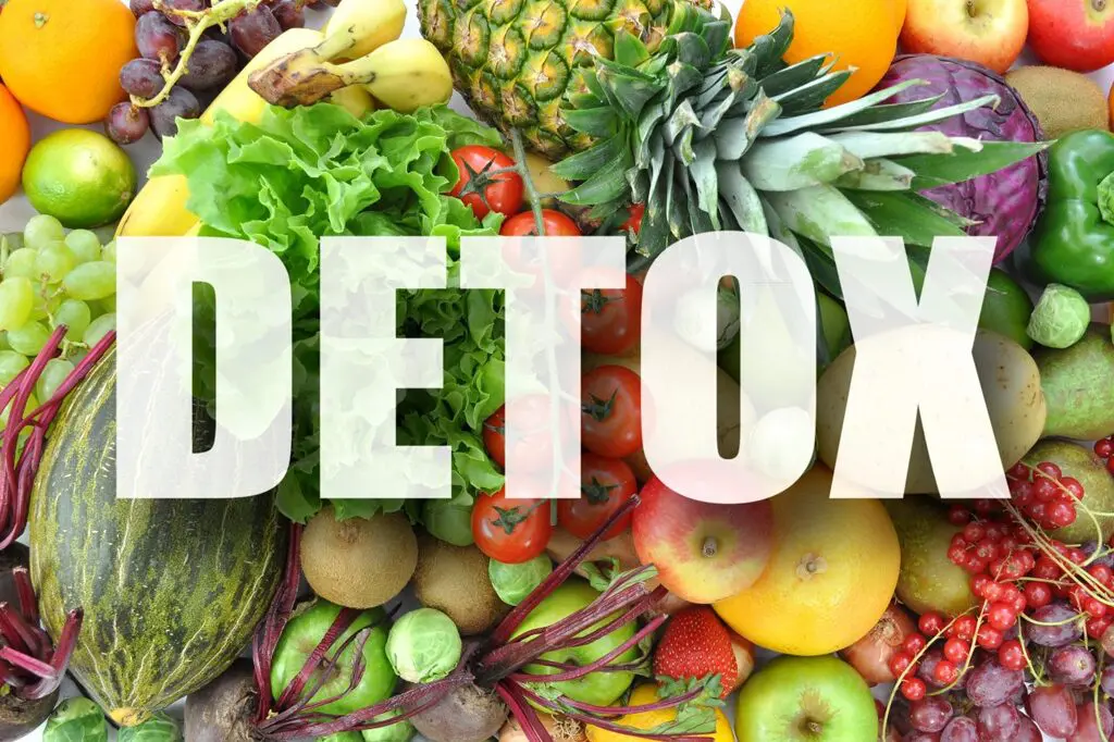 A pile of fruits and vegetables with the word detox in front.