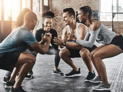 A group of people that are sitting in the gym