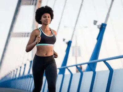 A woman is running on the bridge