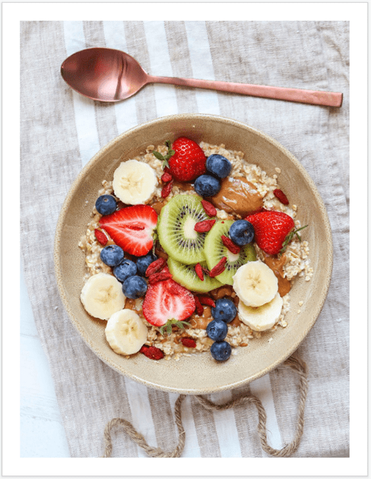 A bowl of cereal with fruit and nuts.