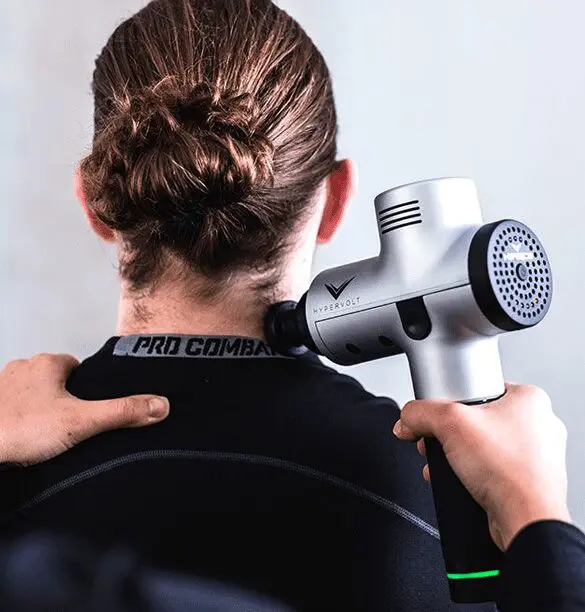 A person holding an electric hair dryer in their hand.