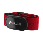 A red polar heart rate monitor on a green background