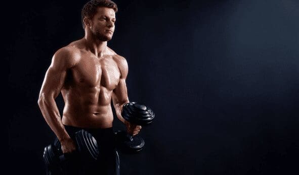 A man holding two dumbbells in his hands.